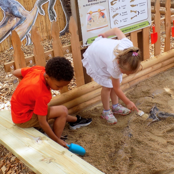 Children dig in sand box