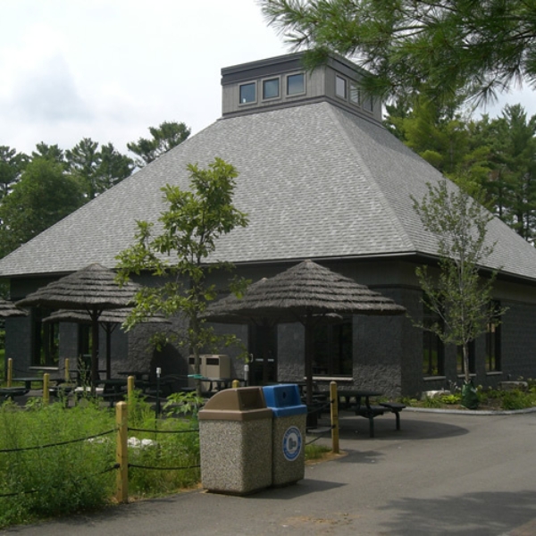 Front of Mayan Restaurant with picnic tables and garbage cans in foreground