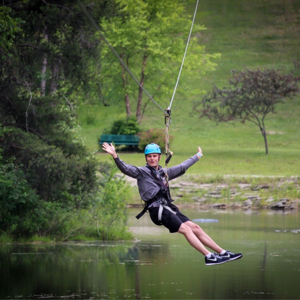 Man hangs from zipline over pond