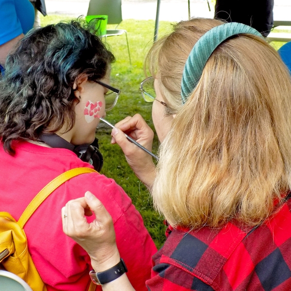 Volunteer paints a face