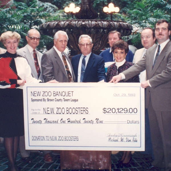  Members of the Boosters stand with a check donation in 1993