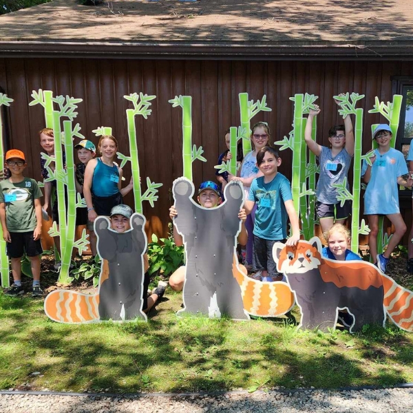 Smiling Campers post for photo near bamboo